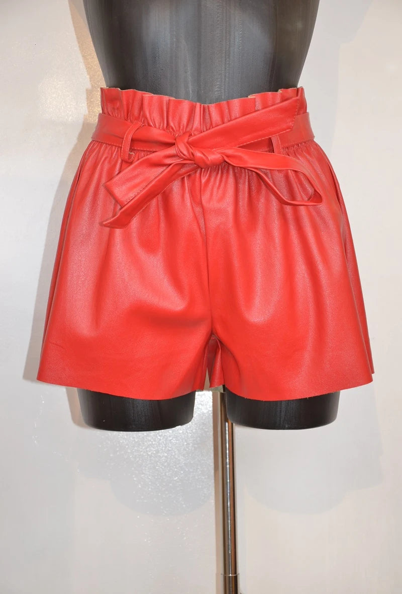 High-waisted faux leather shorts with tied belt