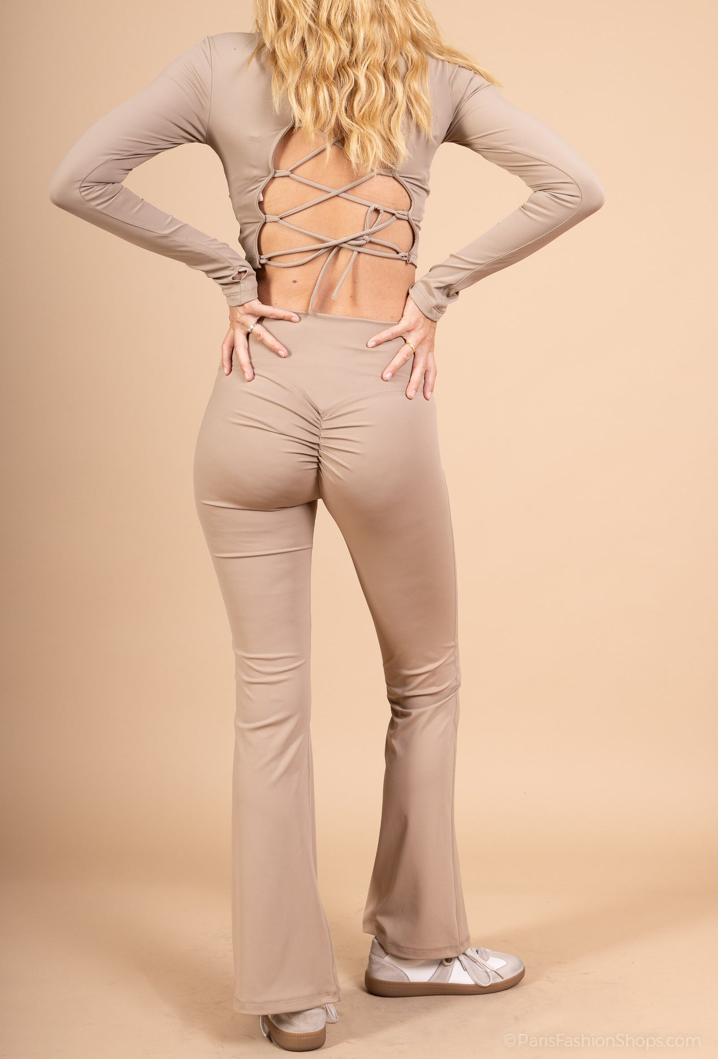Long sleeve lace-up back top and flared pants set, sporty chic style