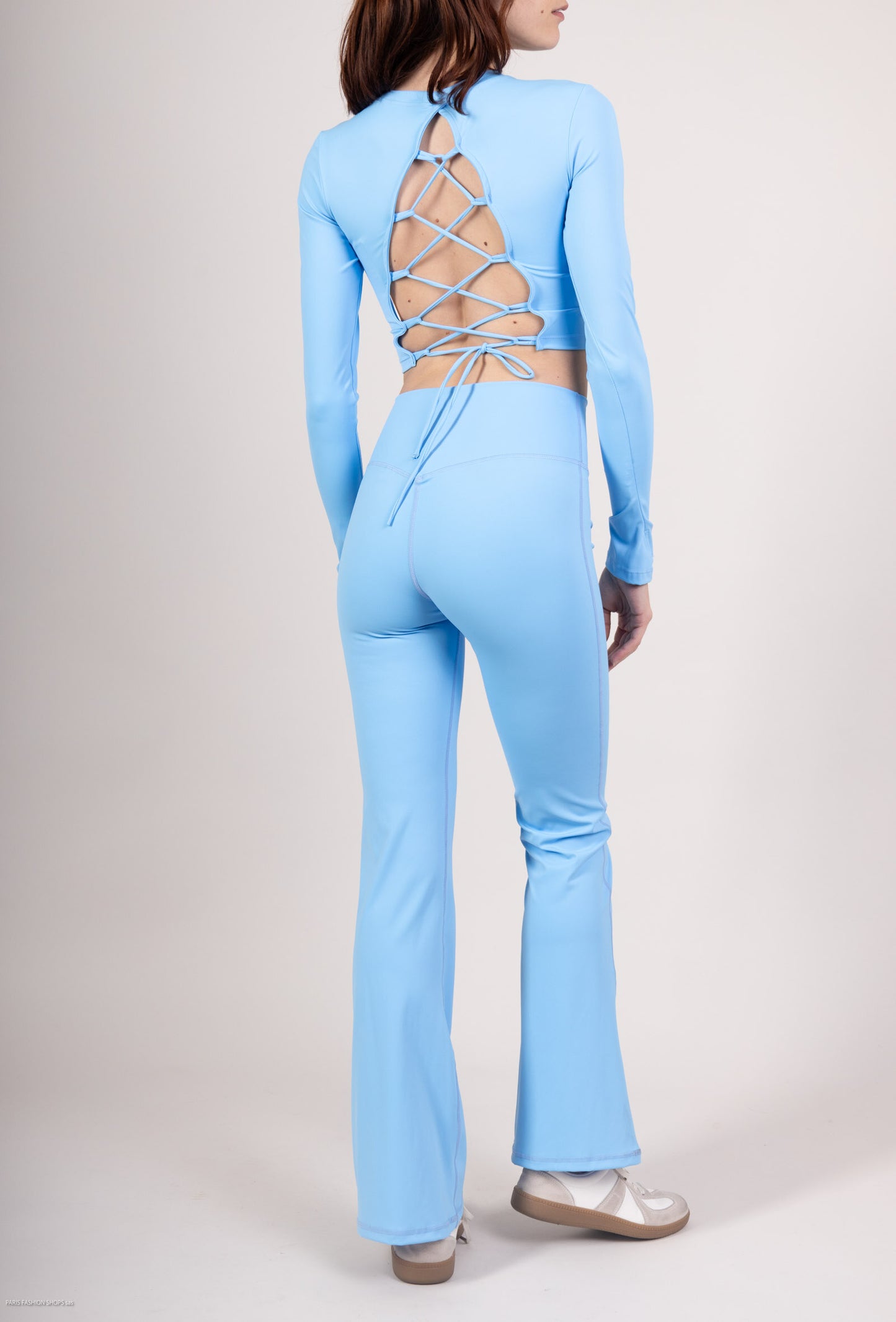 Long sleeve lace-up back top and flared pants set, sporty chic style