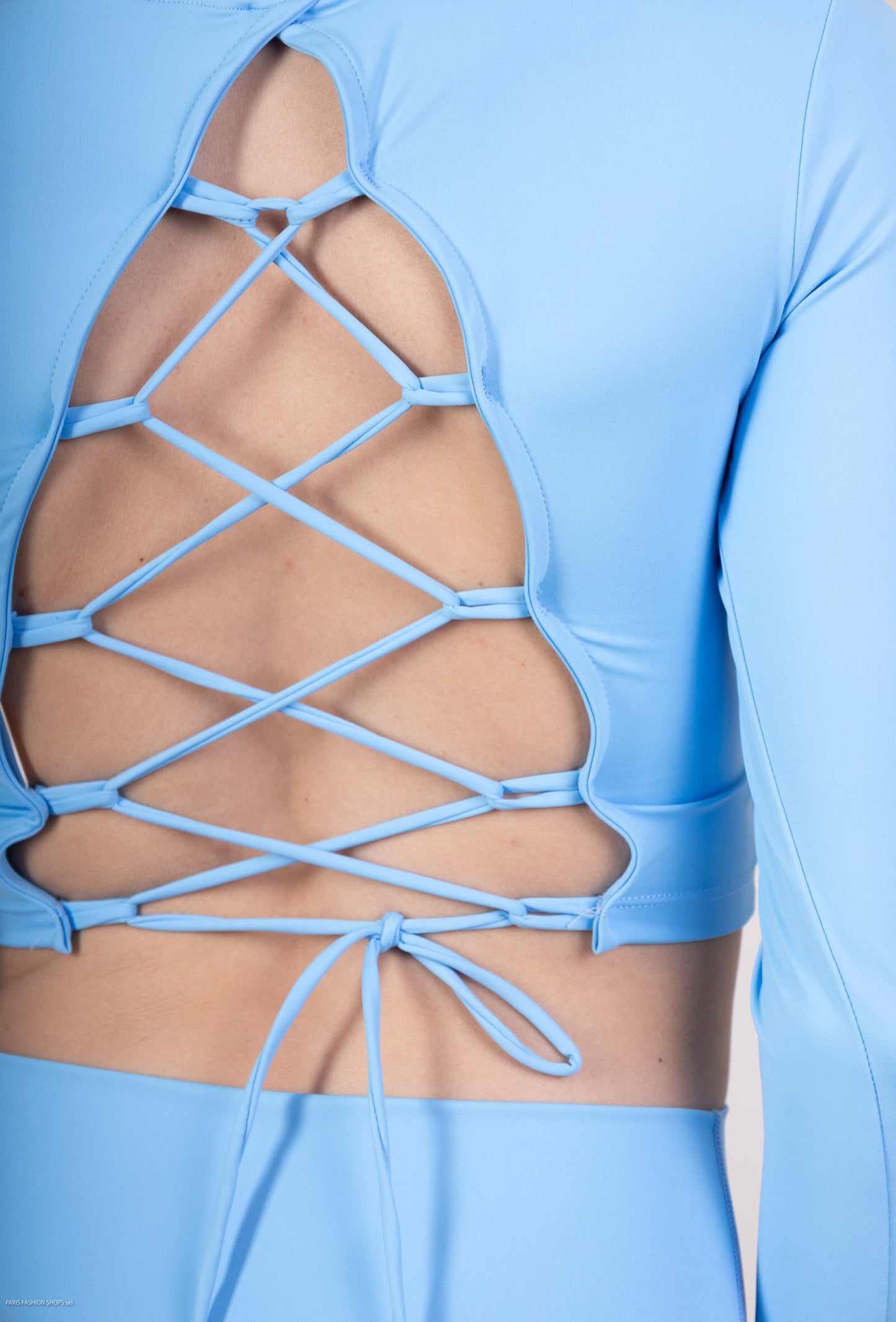 Long sleeve lace-up back top and flared pants set, sporty chic style