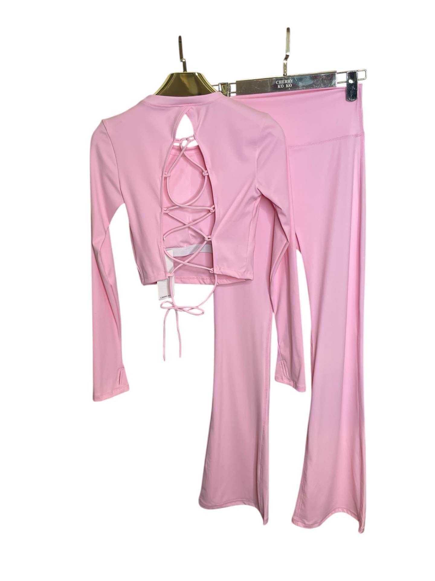 Long sleeve lace-up back top and flared pants set, sporty chic style