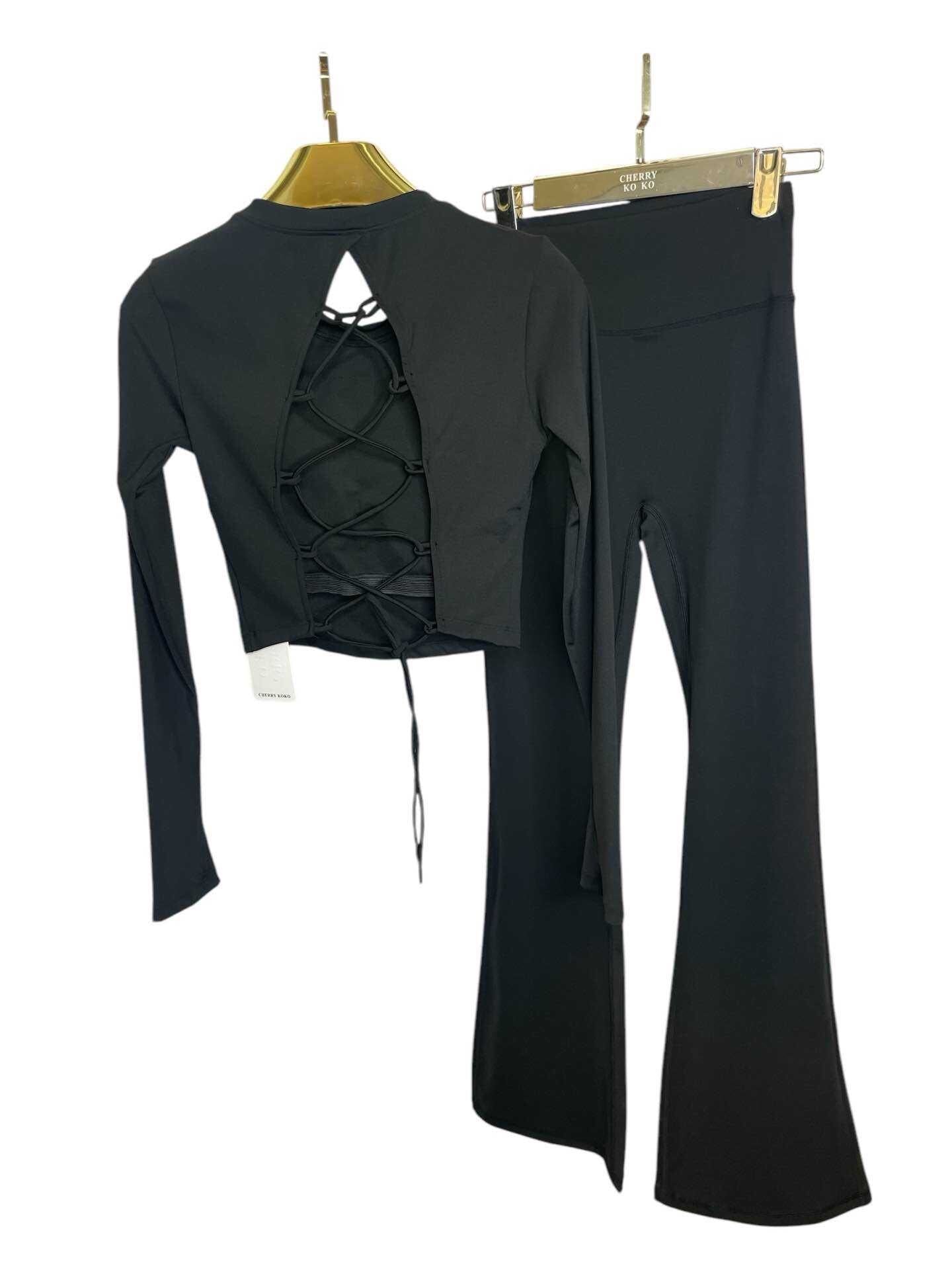 Long sleeve lace-up back top and flared pants set, sporty chic style