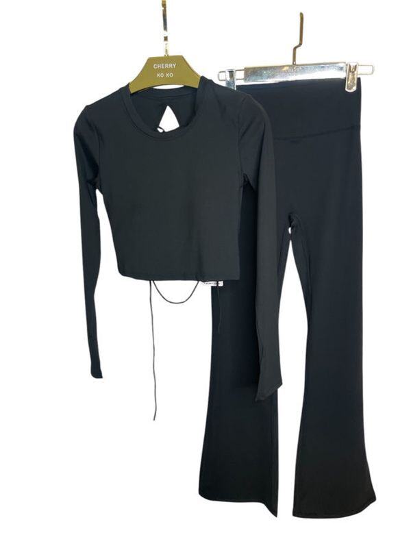 Long sleeve lace-up back top and flared pants set, sporty chic style