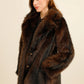 Mid-length faux fur coat with a wide collar, featuring an elegant and trendy cut