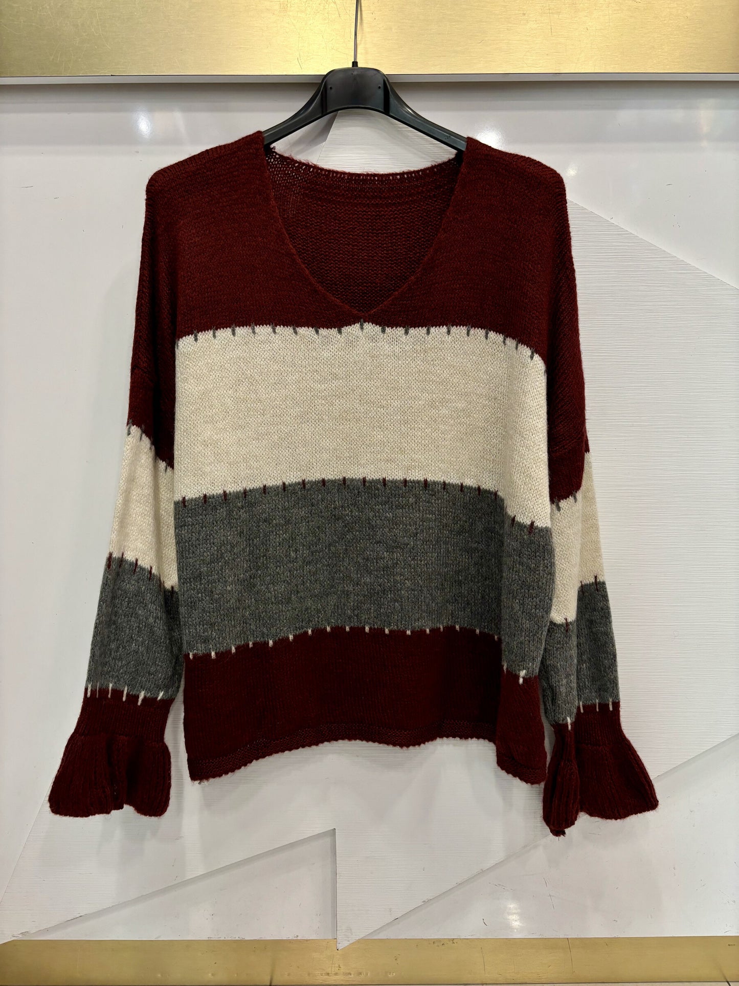 V-neck sweater with multicolored stripes and long sleeves