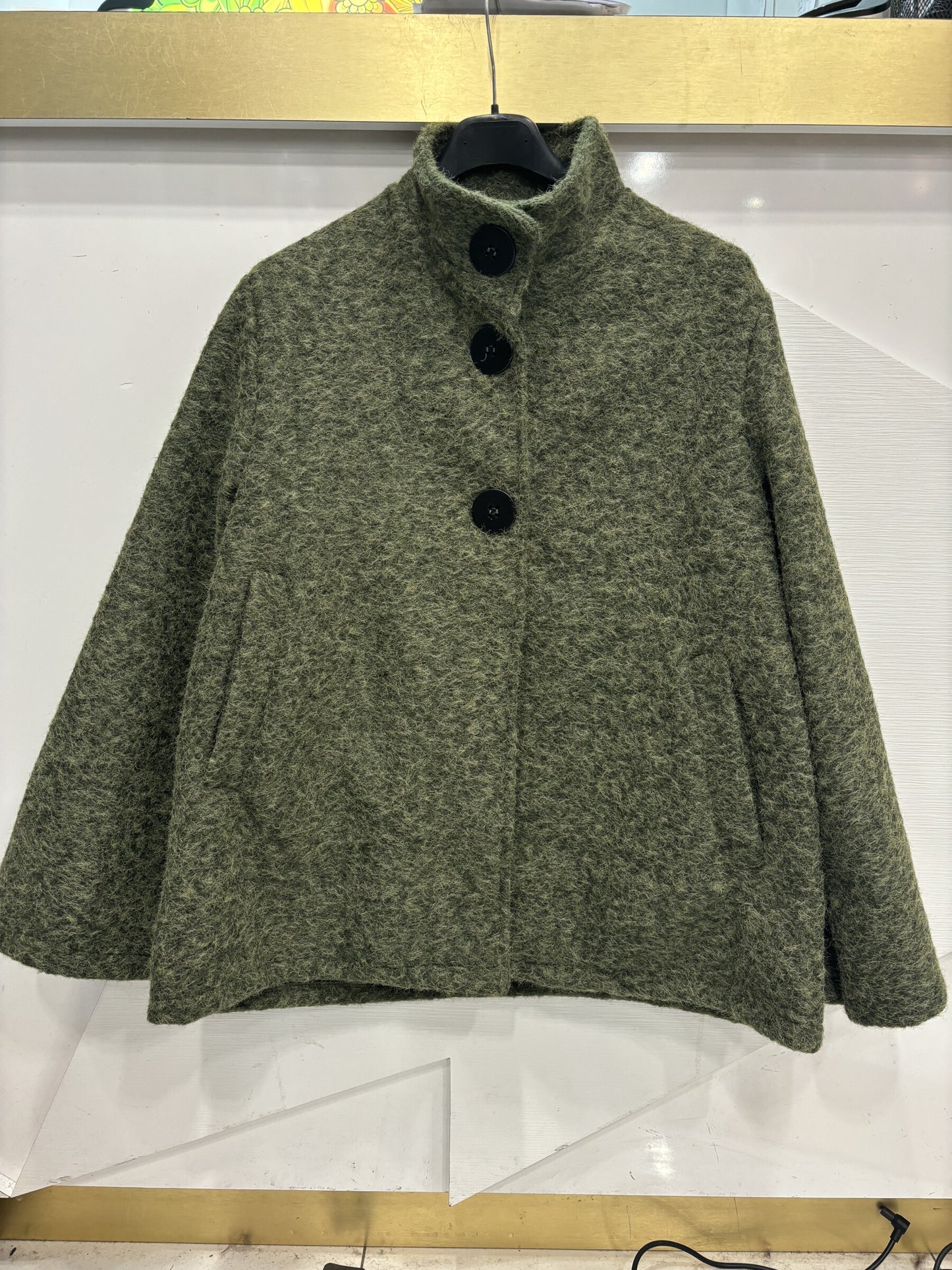 Poncho style wool jacket loop with large black pimples