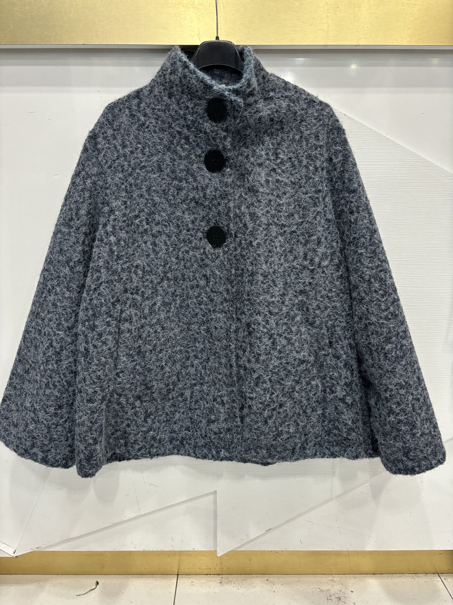 Poncho style wool jacket loop with large black pimples